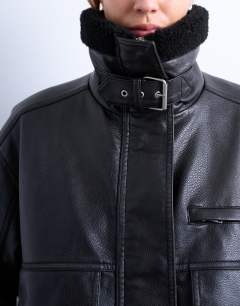 Model wearing Faux leather funnel neck bomber jacket with borg in black