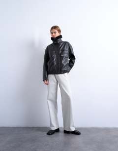 Model wearing Faux leather funnel neck bomber jacket with borg in black