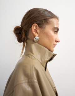 Model wearing Faux leather funnel neck bubble hem top in taupe