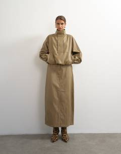 Model wearing Faux leather funnel neck bubble hem top in taupe