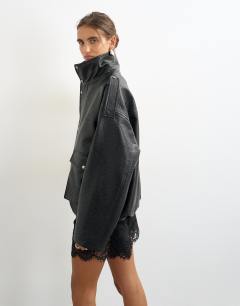 Model wearing Faux leather funnel neck drawstring bomber in black