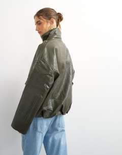Model wearing Faux leather funnel neck drawstring bomber in green