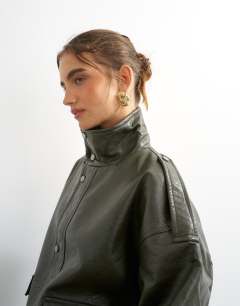 Model wearing Faux leather funnel neck drawstring bomber in green