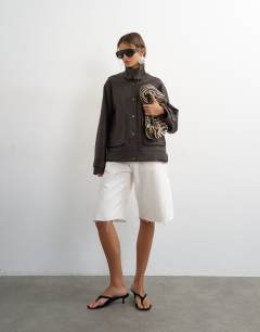 Model wearing Faux leather funnel neck jacket in chocolate