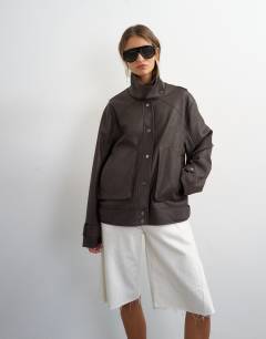 Model wearing Faux leather funnel neck jacket in chocolate