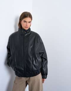 Model wearing Faux leather funnel padded seam detail bomber jacket in black