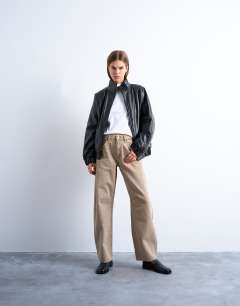 Model wearing Faux leather funnel padded seam detail bomber jacket in black