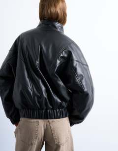 Model wearing Faux leather funnel padded seam detail bomber jacket in black
