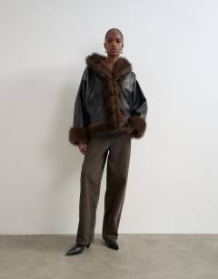 Model wearing Faux leather fur trim jacket in black