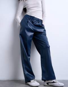 Model wearing Faux leather high waist pleated straight leg trouser in navy