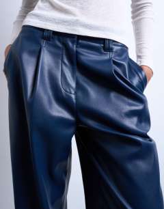 Model wearing Faux leather high waist pleated straight leg trouser in navy