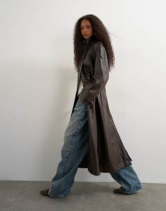 Model wearing Faux leather longline cinch waist trench coat in brown
