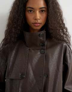 Model wearing Faux leather longline cinch waist trench coat in brown