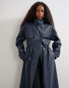 Model wearing Faux leather longline cinch waist trench coat in navy