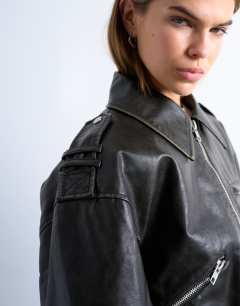 Model wearing Faux leather low belted biker jacket in washed black