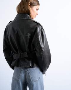 Model wearing Faux leather low belted biker jacket in washed black