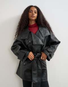 Model wearing Faux leather mid length belted jacket in black