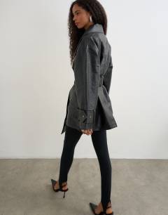 Model wearing Faux leather mid length belted jacket in black