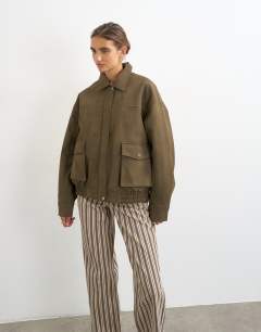 Model wearing Faux leather oversized bomber jacket in brown
