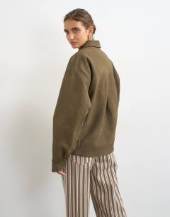 Model wearing Faux leather oversized bomber jacket in brown