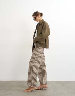 Model wearing Faux leather oversized bomber jacket in brown