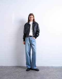 Model wearing Faux leather ovoid sleeve bomber jacket in washed black