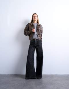 Model wearing Faux leather ovoid sleeve  bomber jacket in washed brown