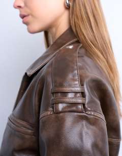 Model wearing Faux leather ovoid sleeve  bomber jacket in washed brown