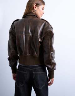 Model wearing Faux leather ovoid sleeve  bomber jacket in washed brown