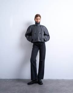 Model wearing Faux leather ovoid sleeve short trench in washed black