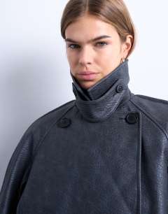 Model wearing Faux leather ovoid sleeve short trench in washed black