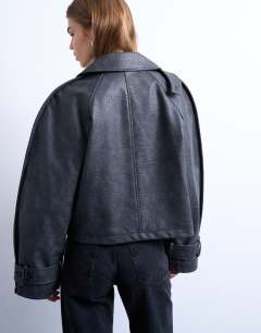 Model wearing Faux leather ovoid sleeve short trench in washed black