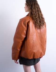 Model wearing Faux leather padded puffer jacket in burnt orange