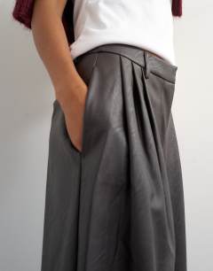Model wearing Faux leather pleated in chocolate