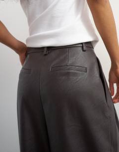Model wearing Faux leather pleated in chocolate