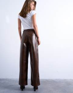 Model wearing Faux leather pleated straight leg trouser in rust