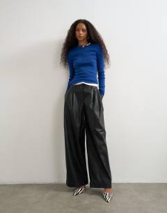 Model wearing Faux leather pleated trouser in black