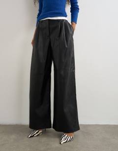 Model wearing Faux leather pleated trouser in black