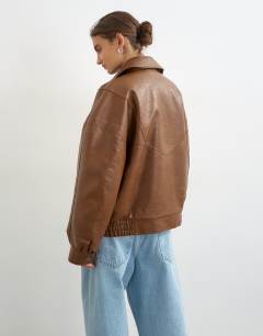 Model wearing Faux leather seam detail bomber jacket in tan