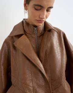 Model wearing Faux leather seam detail bomber jacket in tan