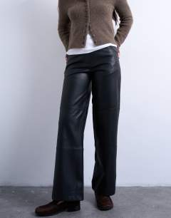 Model wearing Faux leather seam detail straight leg trouser in black