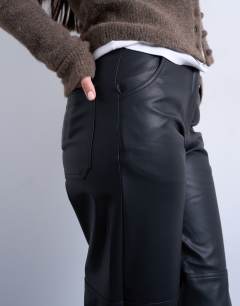 Model wearing Faux leather seam detail straight leg trouser in black