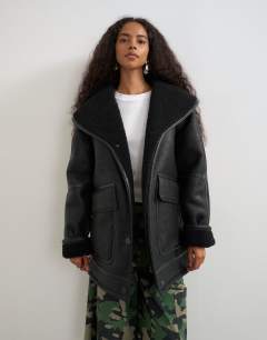 Model wearing Faux leather shearling jacket with patch pockets in black