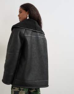 Model wearing Faux leather shearling jacket with patch pockets in black