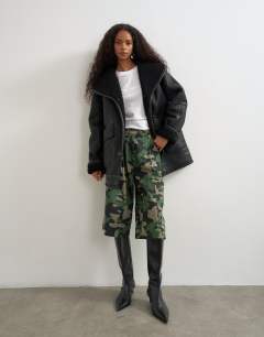 Model wearing Faux leather shearling jacket with patch pockets in black