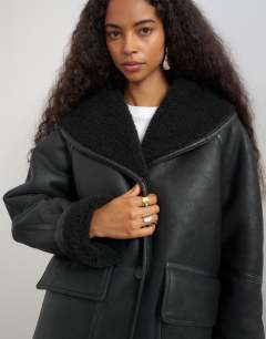 Model wearing Faux leather shearling jacket with patch pockets in black
