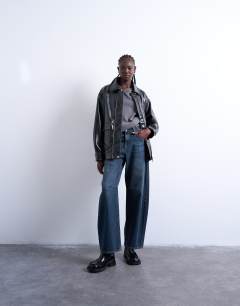 Model wearing Faux leather shiny mottled patch pocket shacket in black