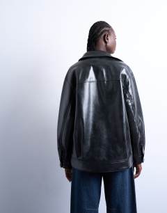Model wearing Faux leather shiny mottled patch pocket shacket in black