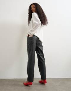 Model wearing Faux leather straight leg trousers in black