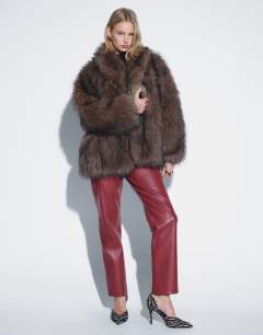 Model wearing Faux leather straight leg trousers in cherry